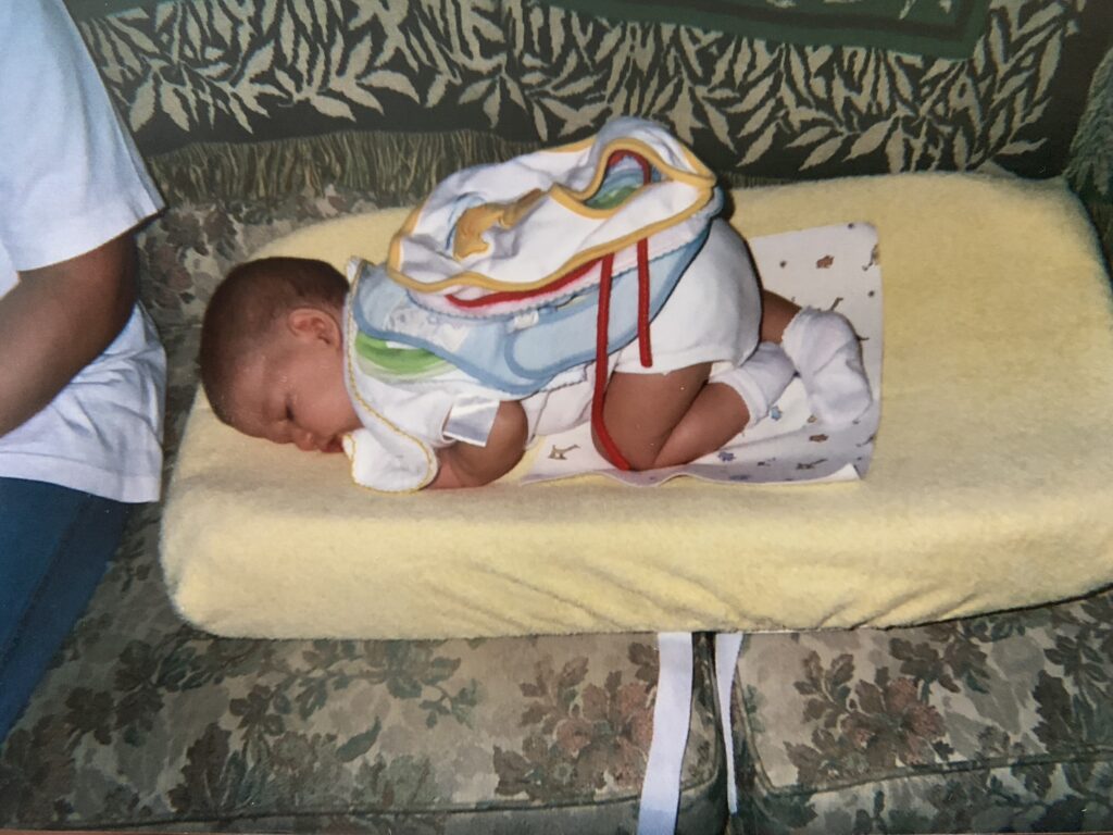 The diaper changing pad was a resting place for a napping Joseph. I am seated next to him.